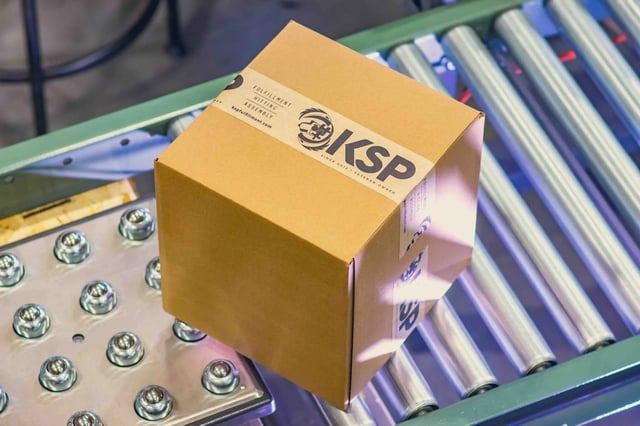 KSP-branded shipping box on a roller conveyor in KSP Fulfillment's warehouse