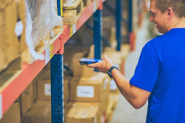 warehouse staff scanning inventory with barcode scanner