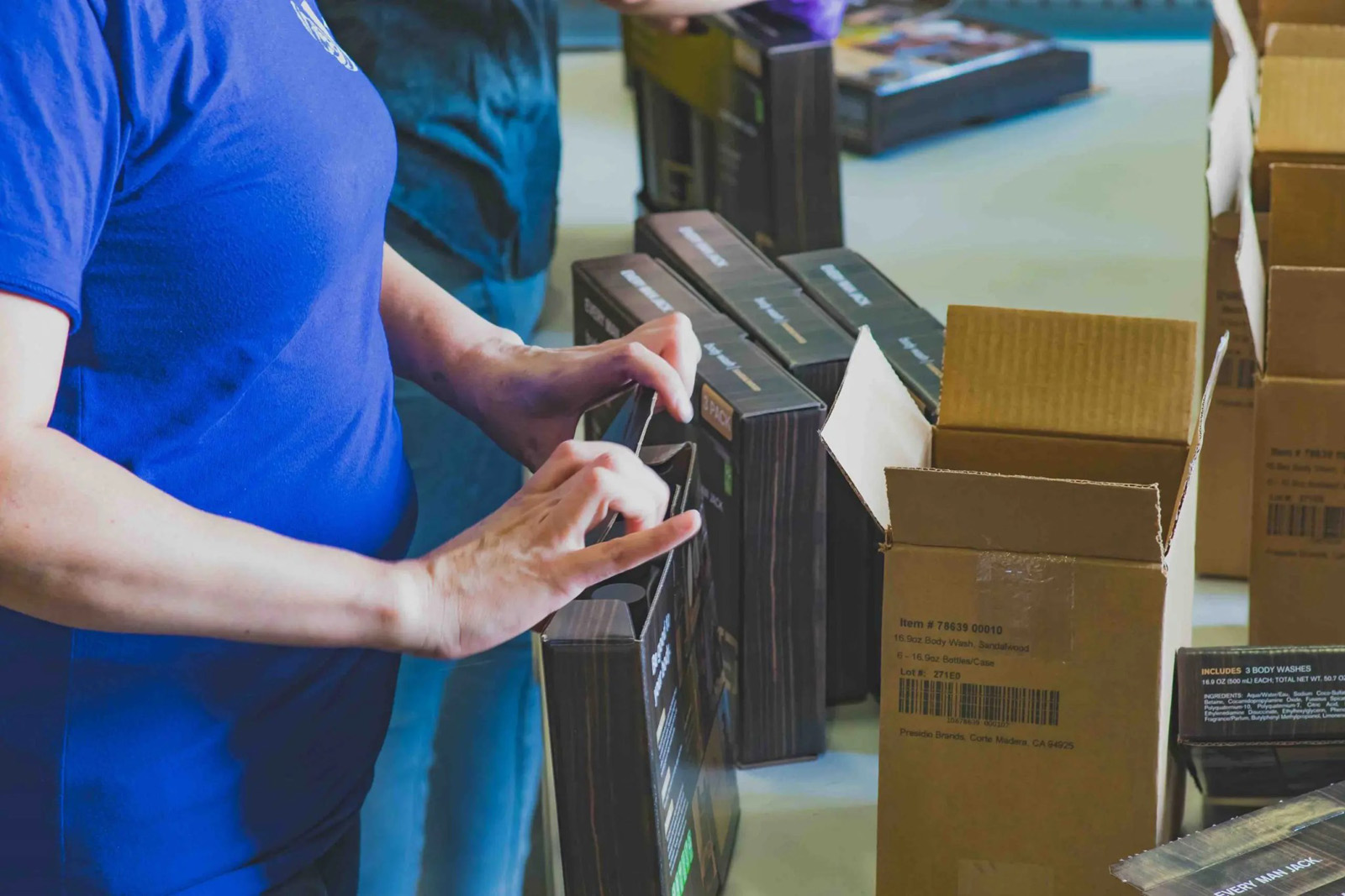 KSP team member assembling 3-pack body wash kits on the kitting floor